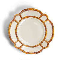 Four decorative plates with brown rattan-like rim on a white background