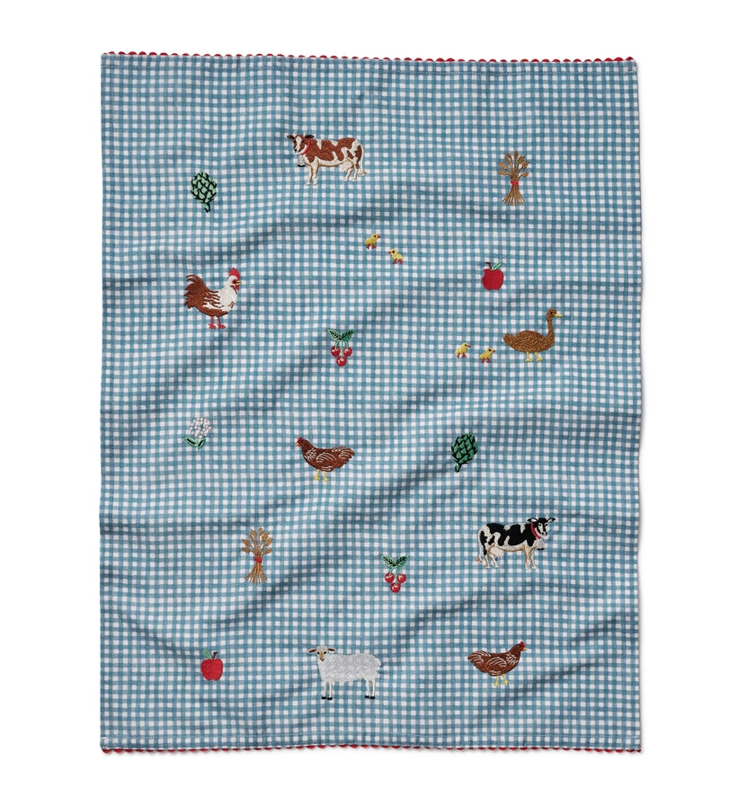 Checkered fabric with farm animal and vegetable patterns on a white background