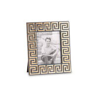 Decorative photo frame with a Greek key pattern holding a black and white photo of a person.