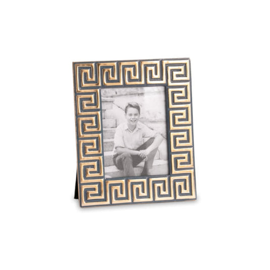 Decorative photo frame with a Greek key pattern holding a black and white photo of a person.