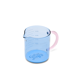 Blue measuring cup with pink handle on a white background