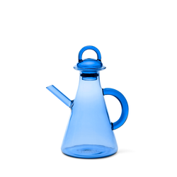 Blue glass oil bottle with a handle on a white background