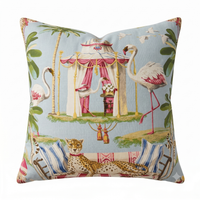 Decorative pillow with a tropical design featuring flamingos, a tent, and a cheetah.
